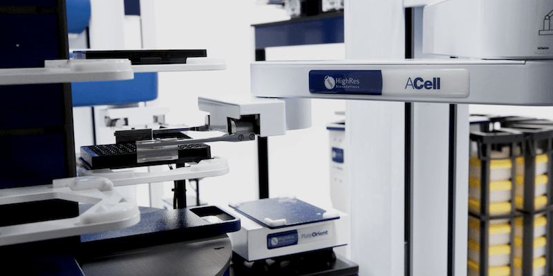 Close-up of an automated liquid handling and plate management system by HighRes Biosolutions, showcasing robotic arms and modular lab automation components designed for high-throughput screening and workflow orchestration.